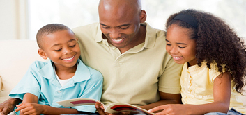 Description: http://fyihouston.info/wp-content/uploads/2014/06/parent-reading-to-kids-pic.jpg