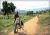 A man poses with his bicycle in front of the beautiful landscape in the Chikwawa region.