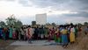 While the sun goes down, a crowd gathers just before the Jesus Film.