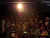 Before the Jesus film starts, a group of children watch while William and Henderson play music.