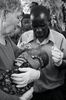 Shirley Williams and Stanley George pray over a baby in the village of Jessey, Chikwawa.