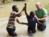 Team members Paul Ilgers (rt) and Snoya Liwonde (lt) led a baptism in a river near the village of Do