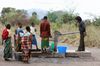 Team member William DeLeon gives some of the village women a rest by pumping water for them.