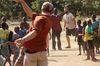 Team Leader Alex Springer plays World Ball with a group of children.